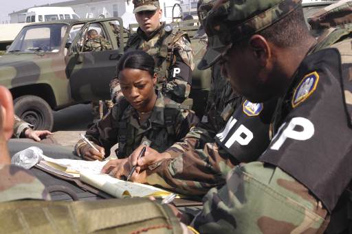 Click to close this view U.S. Army Reserve military police officers discuss options for clearing the roadways in front of the Super Dome in New Orleans, La., on Sept. 2, 2005. The Federal Emergency Management Agency is working with both military and government during humanitarian relief efforts in support of Joint Task Force Katrina.