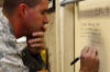 2009 GAC TV Tour - SSGT Scott Lilley signs the "Wall" at Balad AB Hospital on Thursday, October 29th. This is the hospital where Scott was flown for treatment (and where they ultimately saved his life) after his injury in Baghdad. This is also the base where Joe Bowser was injured and treated in this same hospital.