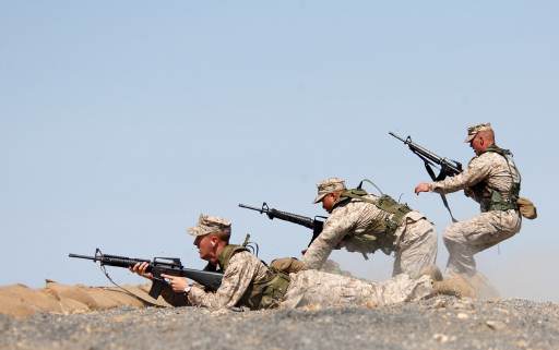 Click to close this view U.S. Marine Corps Lance Cpls. Graham Goodman, Jimmy Nettavong and Steven Jacobs, all members of the Provisional Security Company, compete in a firing drill during the East African Armed Forces Rifle Championship held at Stony-Athi Range in Nairobi, Kenya, Sept. 23, 2005.